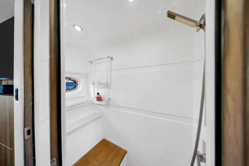 Slide: The Image of Interior of 2017 Regal 53 Sport Coupe yacht bathroom with modern fixtures and wooden accents. - 76