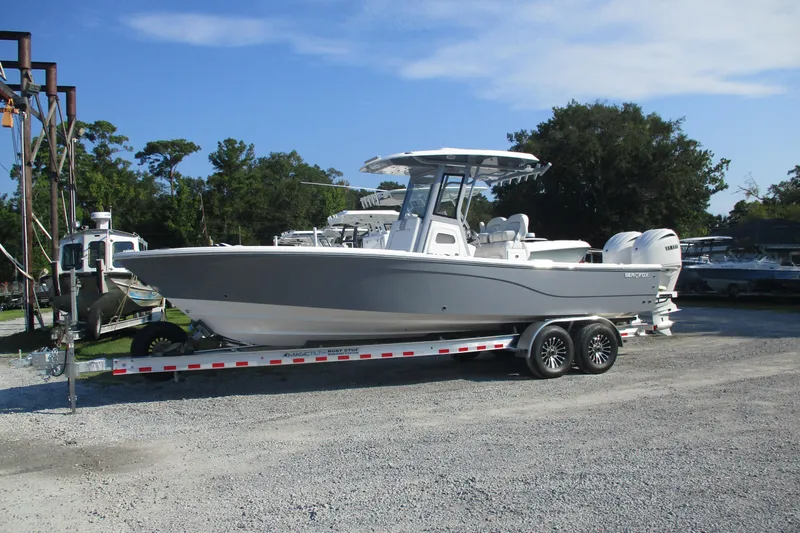 Slide: The Image of 2026 Sea Fox 282 Hybrid LT boat on trailer, parked outdoors under clear sky. - 1