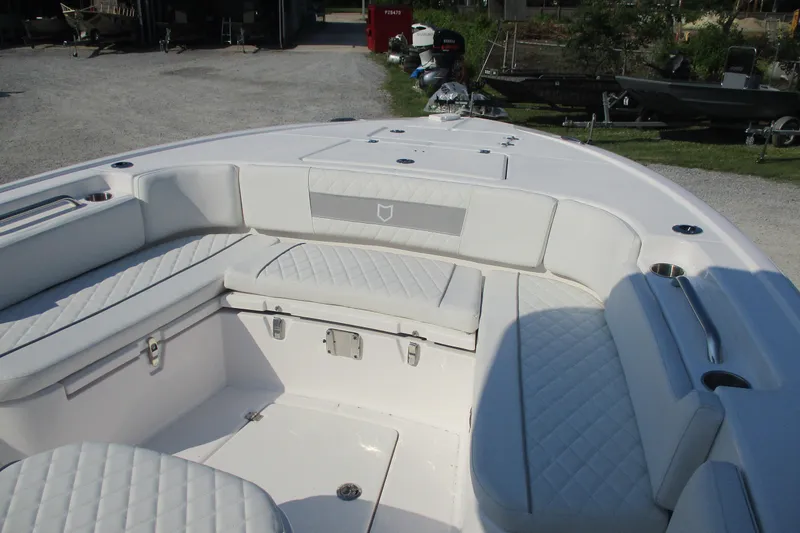 Slide: The Image of 2026 Sea Fox 282 Hybrid LT boat interior with white cushioned seating and cup holders. - 12