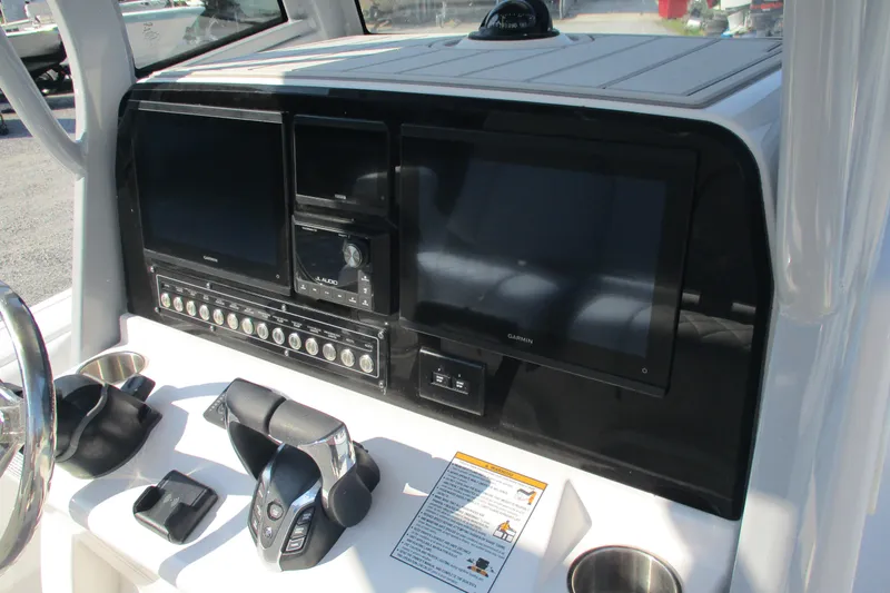 Slide: The Image of Dashboard of 2026 Sea Fox 282 Hybrid LT boat with Garmin displays and controls. - 13
