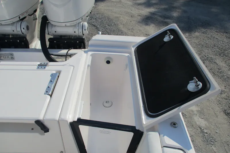 Slide: The Image of 2026 Sea Fox 282 Hybrid LT boat storage compartment with open lid, showcasing interior space. - 15