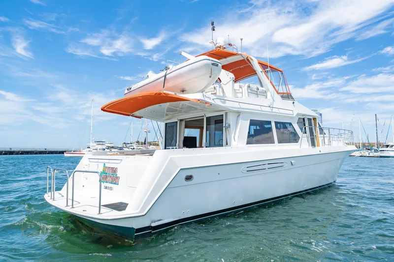 Slide: The Image of 2000 Navigator 5300 Classic yacht on water, clear sky, marina background. - 0