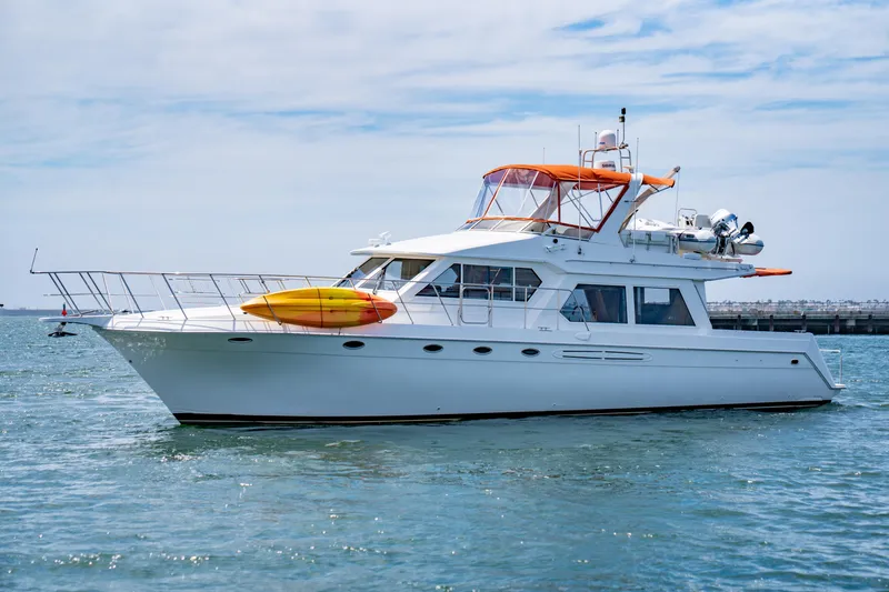 Slide: The Image of 2000 Navigator 5300 Classic yacht with kayaks on deck, cruising in calm waters. - 10