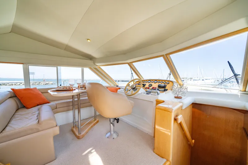 Slide: The Image of Luxurious interior of 2000 Navigator 5300 Classic yacht with panoramic windows and plush seating. - 19