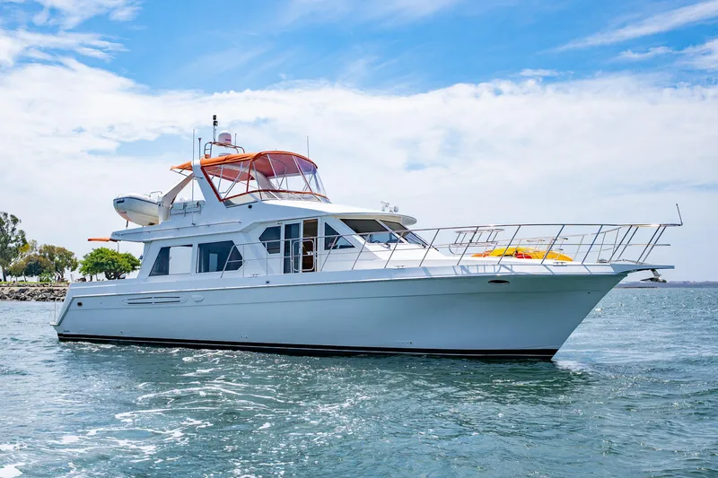 Slide: The Image of Navigator 5300 Classic yacht from 2000 cruising on open water under a clear sky. - 2