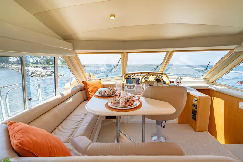 Slide: The Image of Luxurious interior of 2000 Navigator 5300 Classic yacht with elegant dining setup. - 22
