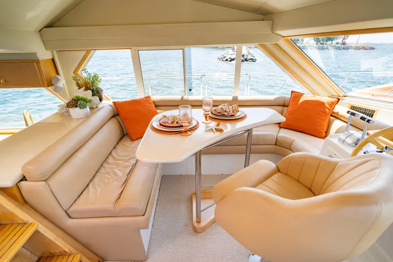 Slide: The Image of Luxurious interior of 2000 Navigator 5300 Classic yacht with elegant seating and dining area. - 23