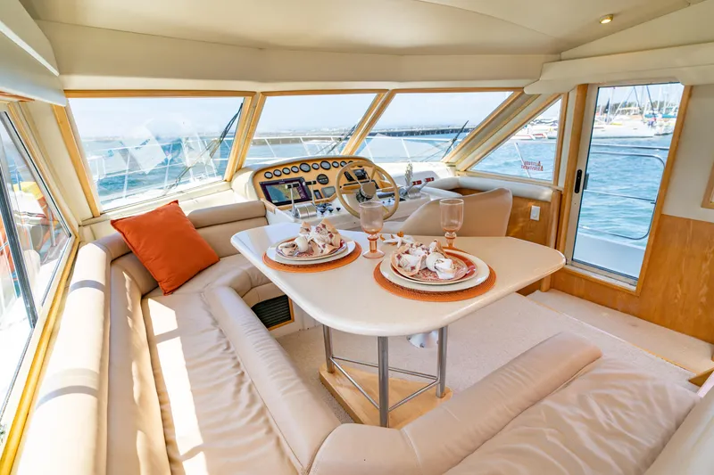 Slide: The Image of Luxurious interior of 2000 Navigator 5300 Classic yacht with elegant dining setup. - 24