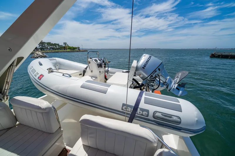 Slide: The Image of Navigator 5300 Classic yacht with inflatable boat and Honda motor on deck, 2000 model. - 28