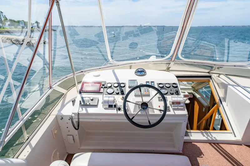 Slide: The Image of Navigator 5300 Classic 2000 yacht helm with ocean view, featuring steering wheel and control panel. - 31