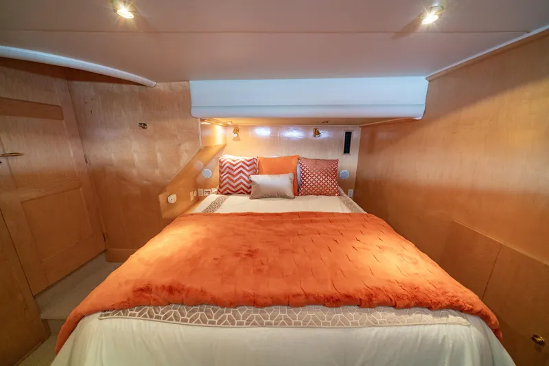 Slide: The Image of Cozy bedroom in 2000 Navigator 5300 Classic yacht with orange bedding and wooden walls. - 32