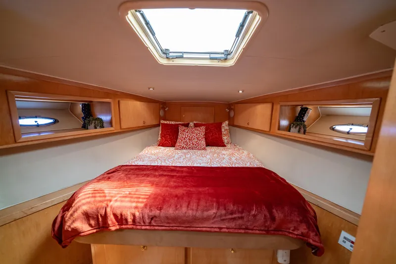 Slide: The Image of Cozy bedroom in 2000 Navigator 5300 Classic yacht with skylight and red bedding. - 38