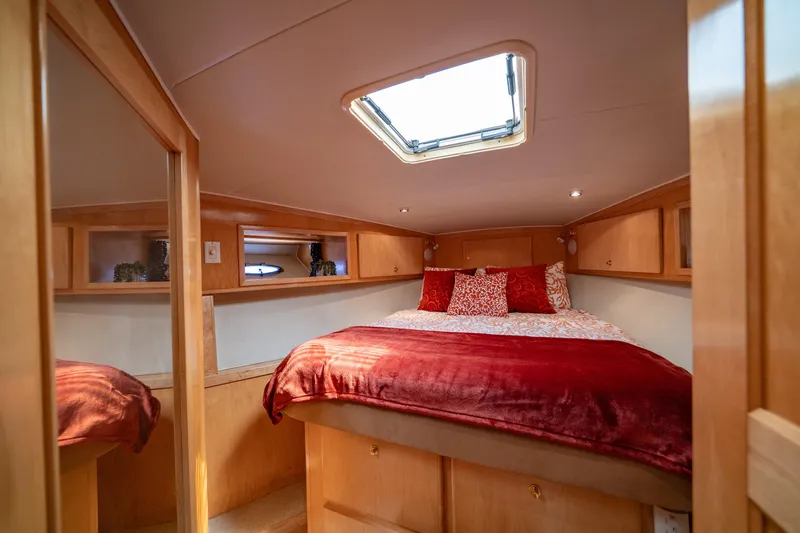 Slide: The Image of Cozy bedroom interior of 2000 Navigator 5300 Classic yacht with skylight and red bedding. - 39