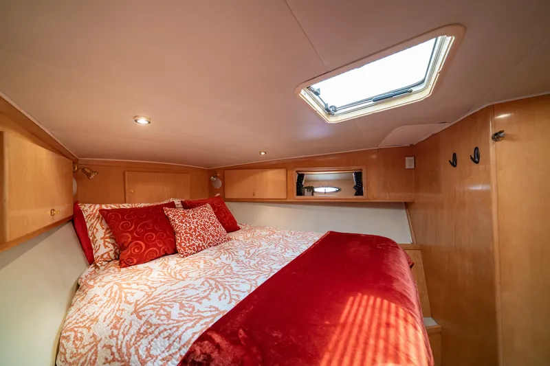 Slide: The Image of Cozy bedroom in 2000 Navigator 5300 Classic yacht with red and white bedding. - 40