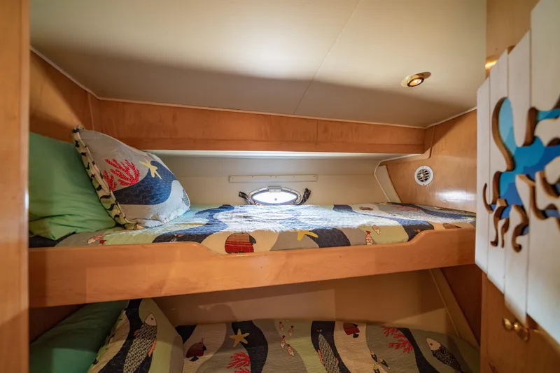Slide: The Image of Bunk beds in 2000 Navigator 5300 Classic yacht cabin with nautical-themed bedding. - 41