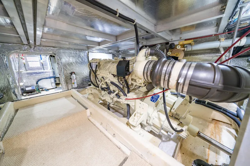 Slide: The Image of Engine room of 2000 Navigator 5300 Classic yacht, showcasing mechanical components and insulation. - 46