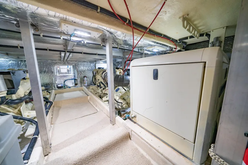 Slide: The Image of Engine room of 2000 Navigator 5300 Classic yacht, featuring machinery and wiring. - 49