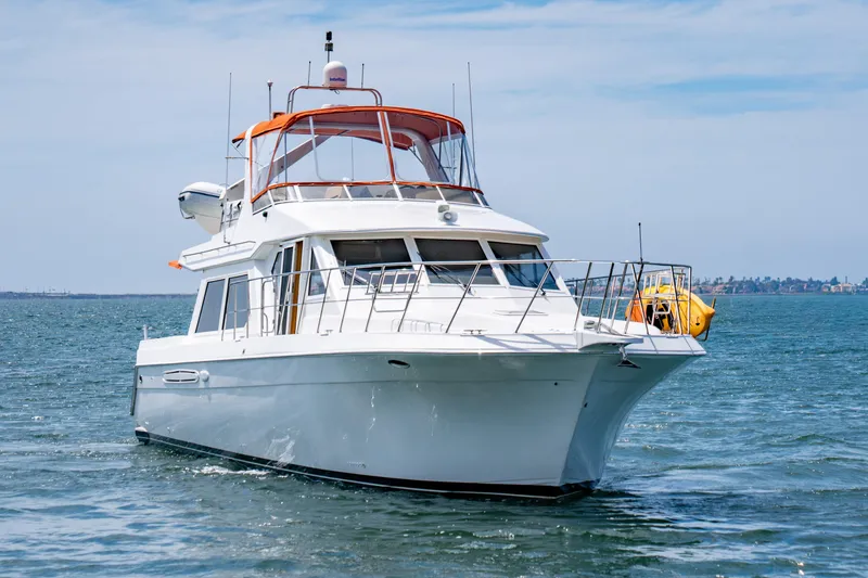 Slide: The Image of 2000 Navigator 5300 Classic yacht cruising on open water under clear skies. - 5