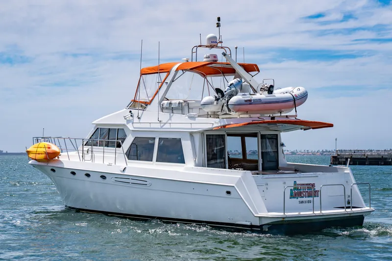 Slide: The Image of 2000 Navigator 5300 Classic yacht with orange canopy cruising in open water. - 7