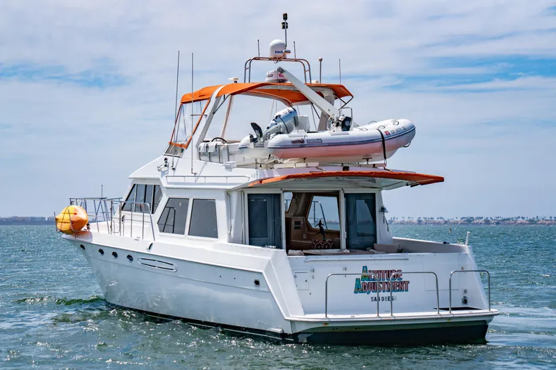 Slide: The Image of Navigator 5300 Classic yacht from 2000 on open water, featuring an orange canopy. - 8