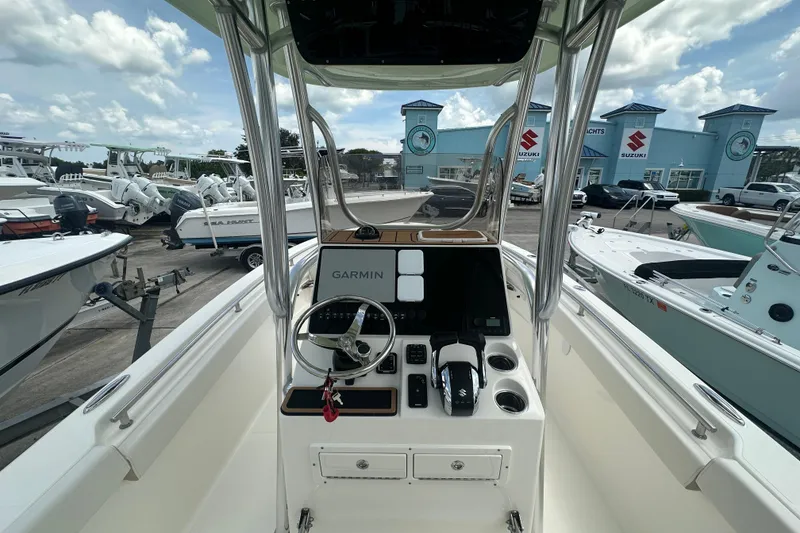 Slide: The Image of 2026 Bulls Bay 255 CC boat dashboard with Garmin navigation, surrounded by other boats. - 6