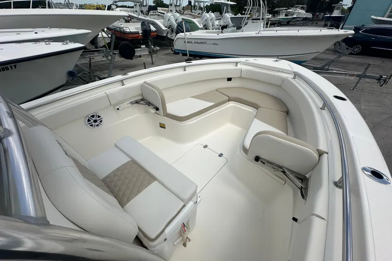 Slide: The Image of 2026 Bulls Bay 255 CC boat interior with white seating and spacious layout. - 7