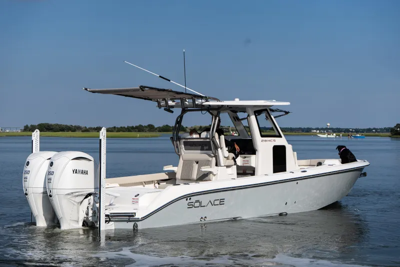 Slide: The Image of 2026 Solace 28 HCS boat with Yamaha engines on calm water. - 1
