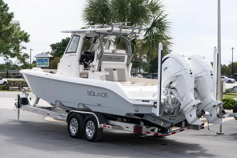 Slide: The Image of 2026 Solace 28 HCS boat on trailer with dual outboard engines. - 17