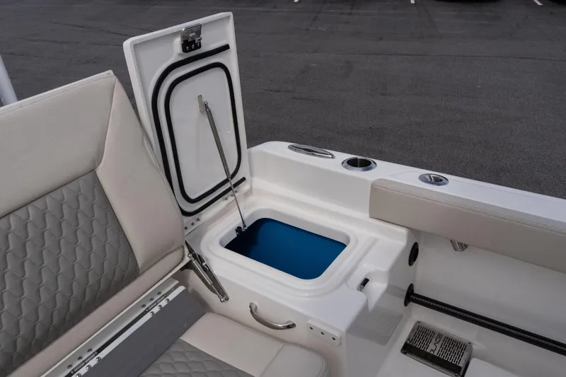 Slide: The Image of 2026 Solace 28 HCS boat interior with open storage compartment and seating. - 23
