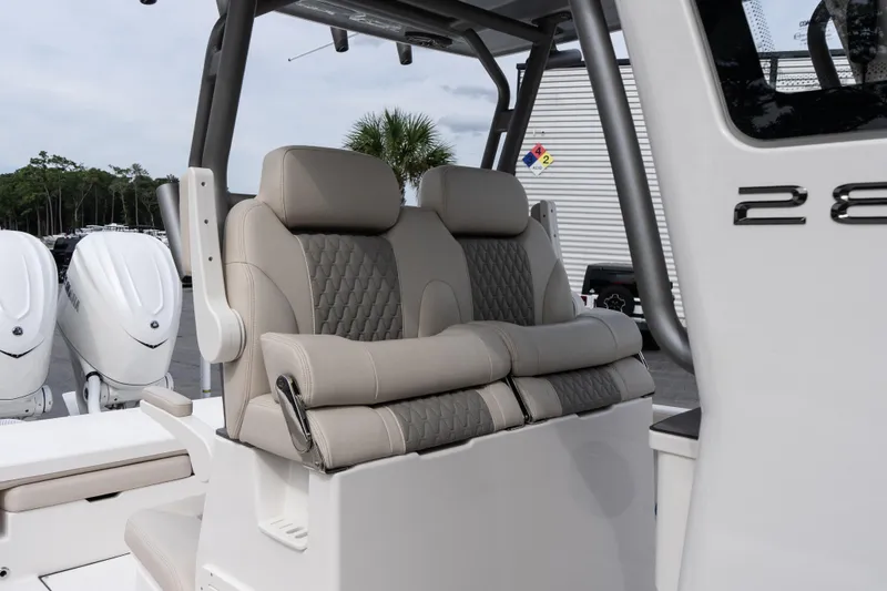 Slide: The Image of Luxury seating on 2026 Solace 28 HCS boat with dual engines in background. - 31