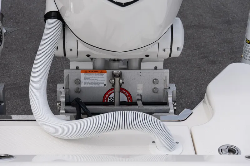 Slide: The Image of 2026 Solace 28 HCS boat engine detail with hose and warning label. - 36