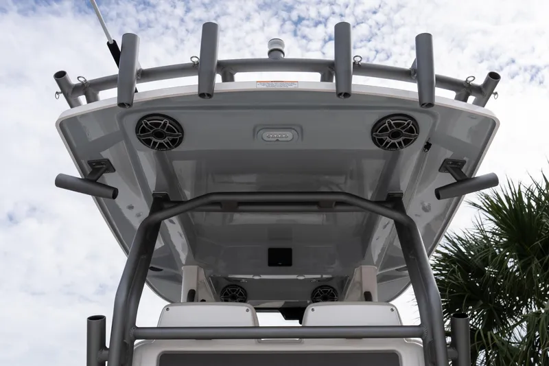 Slide: The Image of 2026 Solace 28 HCS boat roof with rod holders and speakers against cloudy sky. - 38