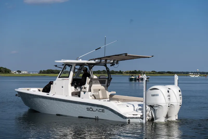 Slide: The Image of 2026 Solace 28 HCS boat with dual Yamaha engines on calm water. - 4