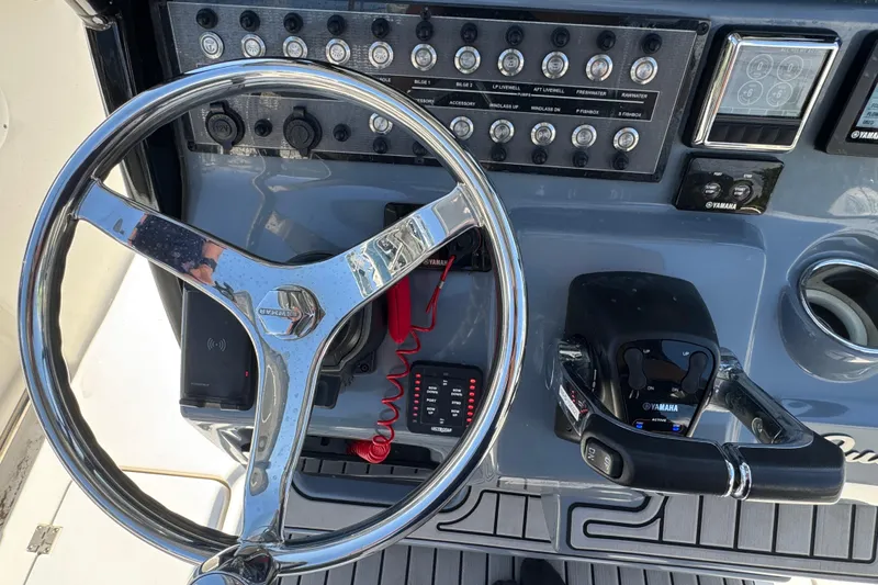 Slide: The Image of Steering console of 2021 Tidewater 272 CC Adventure boat with Yamaha controls. - 11