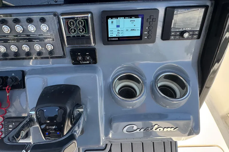 Slide: The Image of Control panel of 2021 Tidewater 272 CC Adventure boat with Yamaha electronics and cup holders. - 12