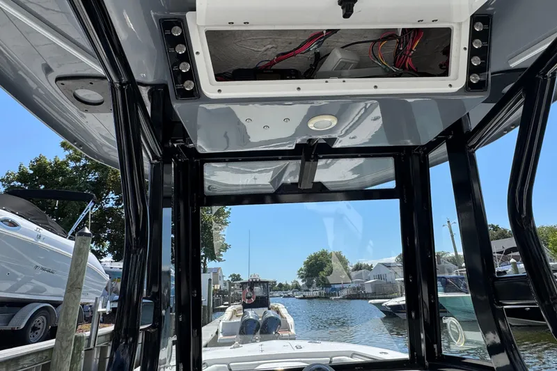 Slide: The Image of 2021 Tidewater 272 CC Adventure boat interior view at a marina. - 16