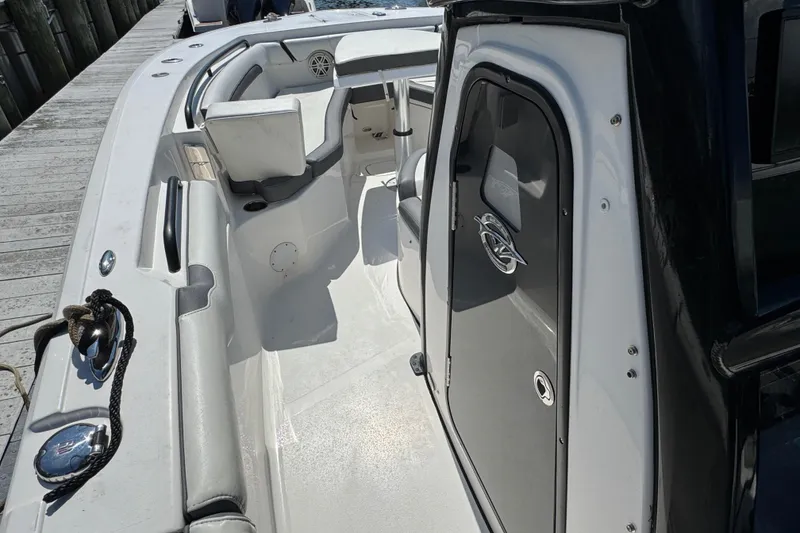 Slide: The Image of 2021 Tidewater 272 CC Adventure boat interior with seating and storage compartments. - 17