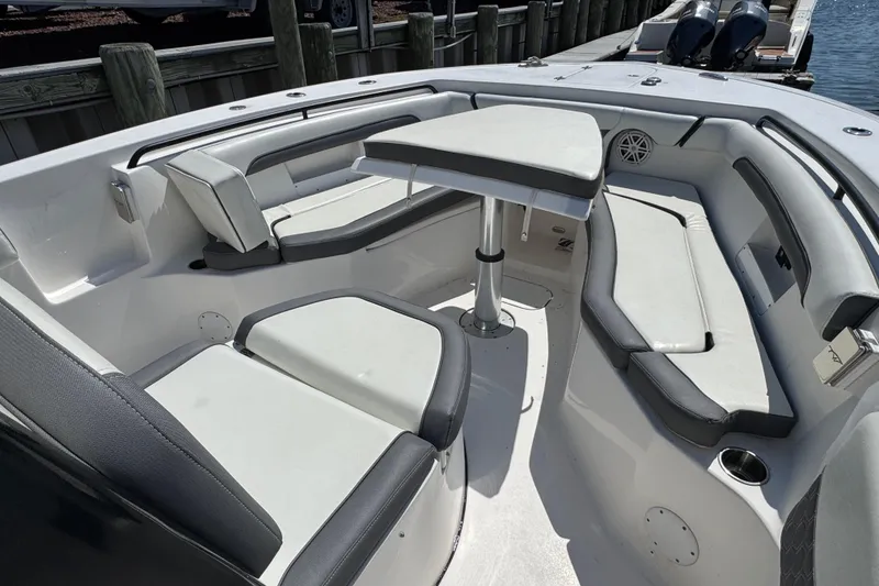 Slide: The Image of 2021 Tidewater 272 CC Adventure boat interior with seating and table. - 21