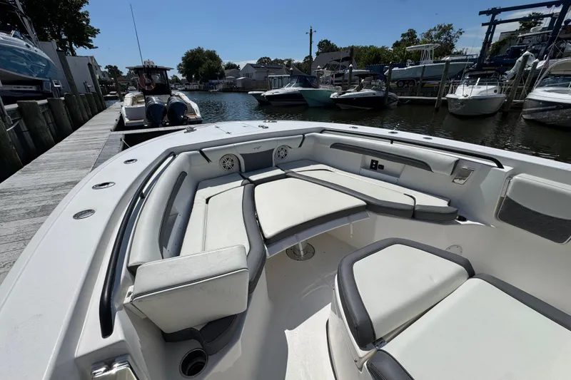 Slide: The Image of 2021 Tidewater 272 CC Adventure boat with spacious seating at a marina dock. - 23