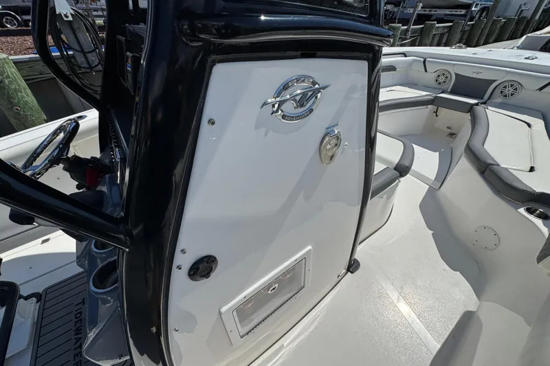 Slide: The Image of 2021 Tidewater 272 CC Adventure boat interior with seating and console details. - 26
