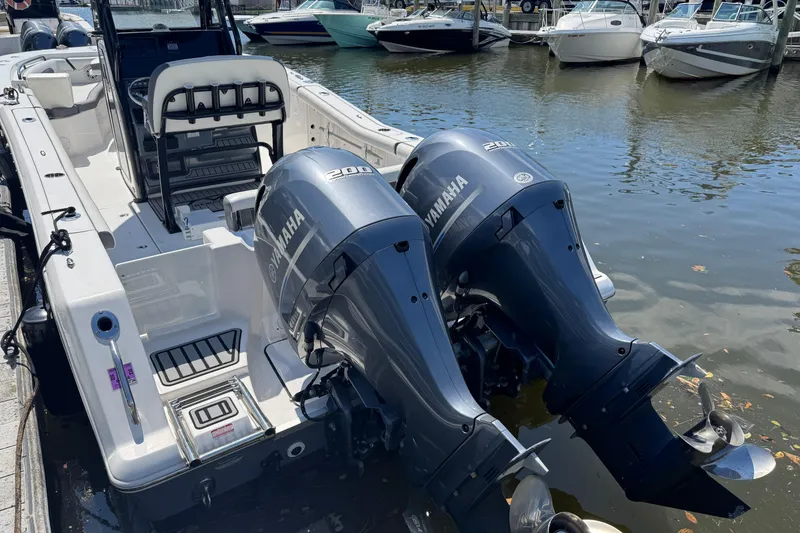 Slide: The Image of 2021 Tidewater 272 CC Adventure boat with dual Yamaha 200 engines docked at marina. - 3