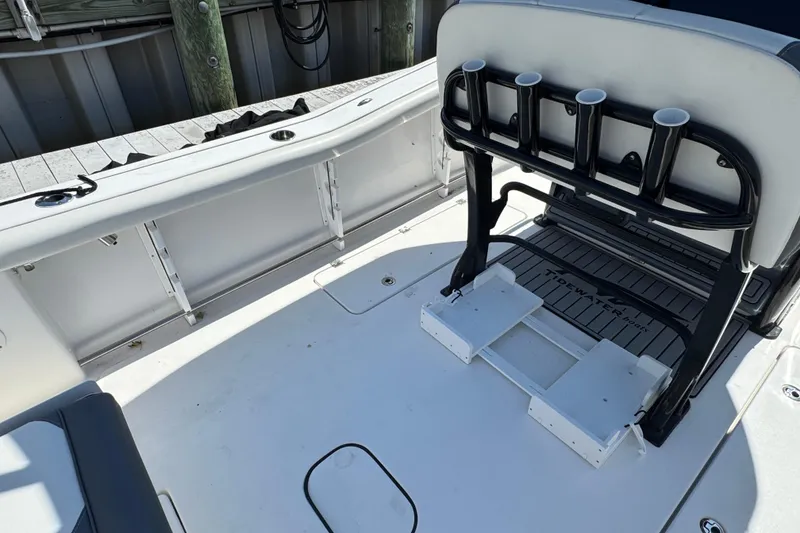 Slide: The Image of 2021 Tidewater 272 CC Adventure boat interior with rod holders and seating. - 5