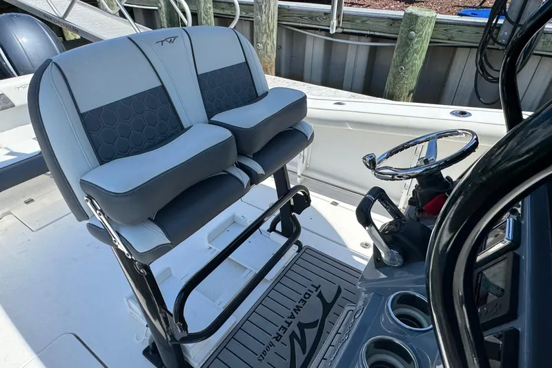 Slide: The Image of 2021 Tidewater 272 CC Adventure boat helm with dual seats and steering wheel. - 8