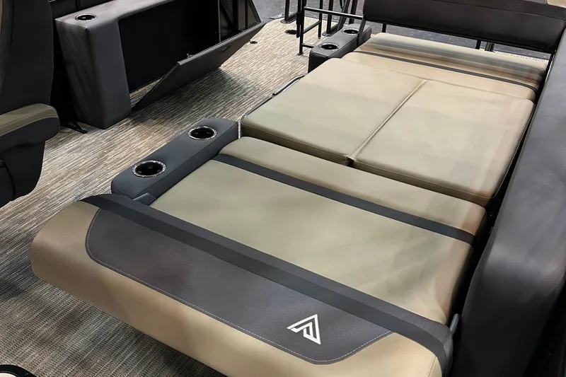 Slide: The Image of 2026 Viaggio Lago X22D Tritoon interior with beige seating and cup holders. - 18