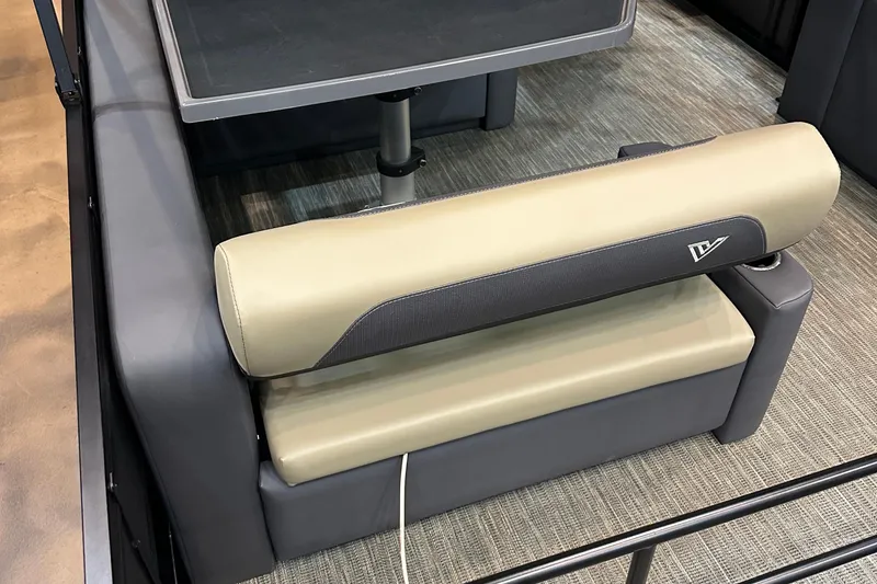 Slide: The Image of Viaggio Lago X22D Tritoon 2026 interior seating with beige and gray upholstery. - 19