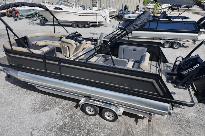 Slide: The Image of 2026 Viaggio Lago X22D Tritoon boat on trailer, featuring Suzuki engine. - 5