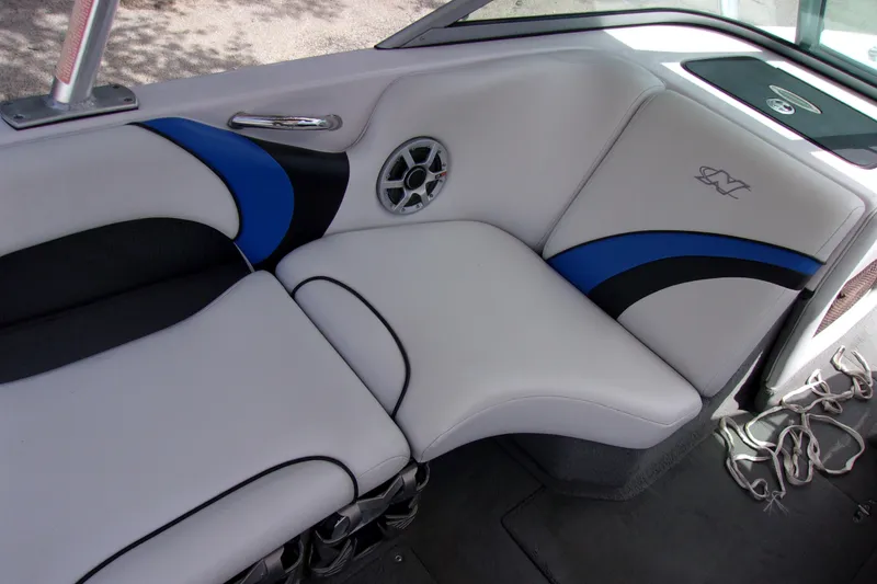 Slide: The Image of 2005 Correct Craft 210 SUPER AIR TEAM EDITION boat interior with white and blue seating. - 10