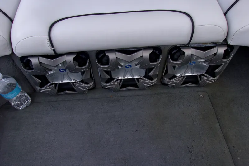 Slide: The Image of 2005 Correct Craft 210 SUPER AIR TEAM EDITION boat interior with custom speakers and seating. - 11