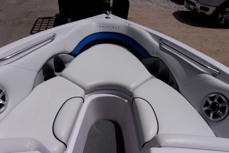 Slide: The Image of 2005 Correct Craft 210 SUPER AIR TEAM EDITION boat interior with white seating and speakers. - 12