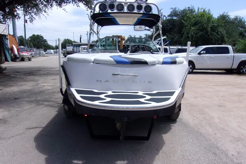 Slide: The Image of 2005 Correct Craft 210 Super Air Team Edition boat, rear view, parked outdoors. - 3